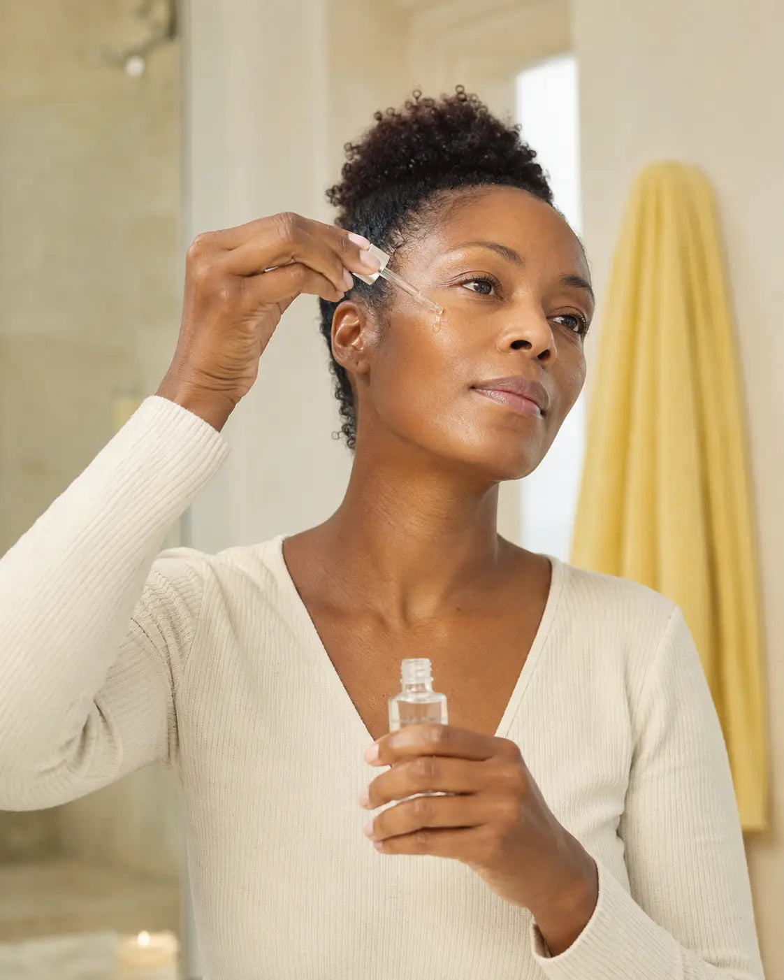 Woman applying hyaluronic acid serum correctly